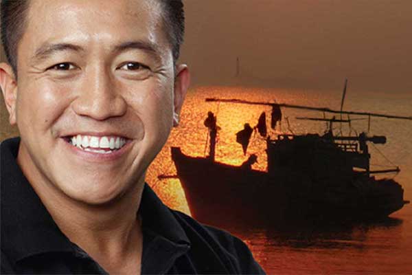 Ahn Do smiling with boat scene in background