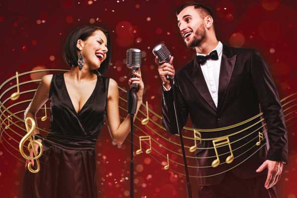 Couple singing on Christmas backdrop