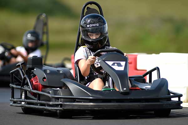 A young girl driving a go kart