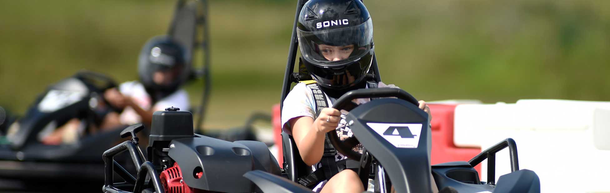 A young girl driving a go kart